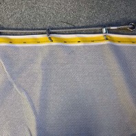 High Strength net with standard buttonhole border connected to a wire rope with quick links